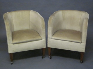 A pair of Edwardian mahogany tub back chairs upholstered in  cream striped material