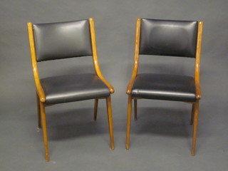 A set of 9, 1960's Designer beech framed dining chairs, the seats and backs upholstered in black rexine