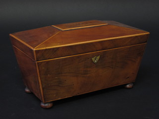 A 19th Century mahogany tea caddy of sarcophagus form, inlaid  satinwood stringing with brass escutcheon, raised on bun feet,  complete with mixing/sugar bowl 12"