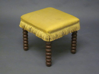 A Victorian square oak stool, on bobbin turned supports 18"