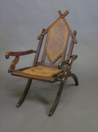A 19th Century mahogany folding campaign chair with woven  cane seat and back
