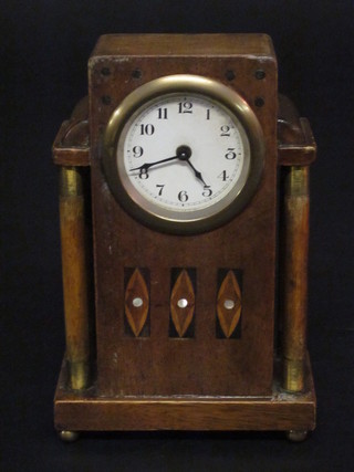 A 1930's bedroom timepiece with paper dial and Arabic numerals contained in an inlaid mahogany case
