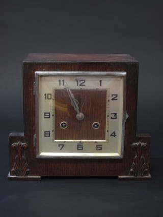An Art Deco 8 day striking mantel clock with square silvered dial  and Arabic numerals contained in an oak case