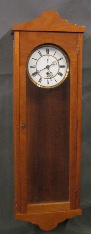 A Vienna style regulator with 6 1/2" dial with Roman numerals  and minute indicator, contained in a mahogany case, no weights,