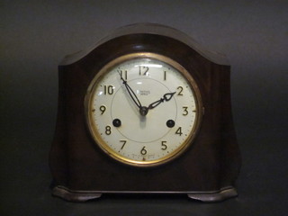 An Art Deco 8 day mantel clock with silvered dial and Arabic  numerals contained in an arch shaped Bakelite case
