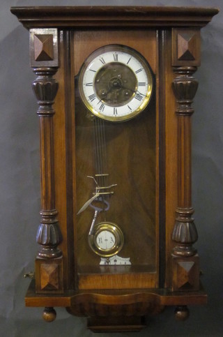 A Vienna style regulator with 5 1/2" dial and Roman numerals contained in a walnut case