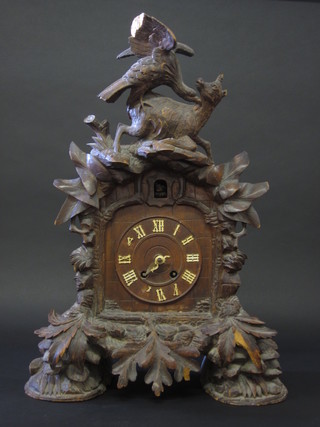 A Bavarian carved wooden cuckoo bracket clock surmounted by  a figure of an eagle and deer, f, 24"
