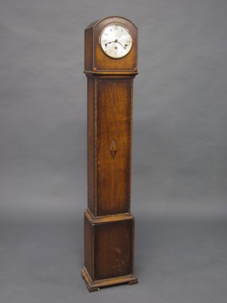 A 1930's 8 day chiming longcase clock with silvered dial and Arabic numerals contained in an oak case 60"