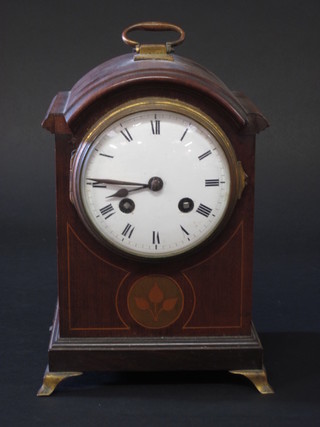 An Edwardian French bracket clock with enamelled dial and Roman numerals contained in an arch shaped inlaid mahogany  case, raised on brass bracket feet, 1 missing, 6"