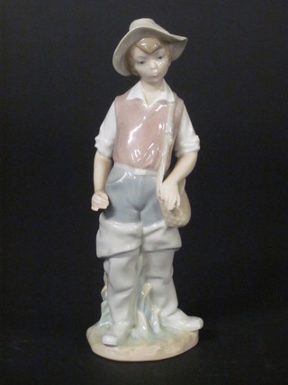 A Lladro figure of a standing fisher boy, 8"