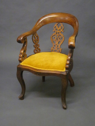A Victorian mahogany tub back armchair with pierced vase  shaped slat back, the seat of serpentine outline, raised on cabriole  supports