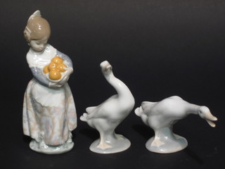 A Lladro figure of a standing girl with basket of fruit 6" and 2 Lladro figures of geese 6"