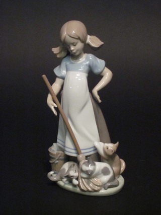 A Lladro figure of standing girl with kittens and broom 8"