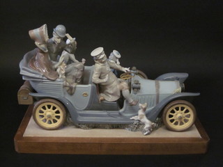 A Lladro limited edition figure group "Familiar Rallye" in the  form of a vintage car with figures therein, 22 1/2", 1 passenger's  foot f,  ILLUSTRATED