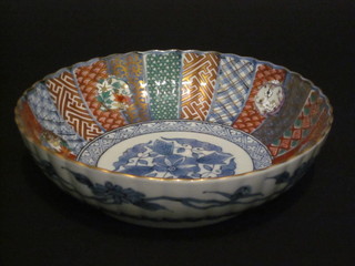 A circular Japanese Imari porcelain bowl with segmented decoration, the base with seal mark 9"