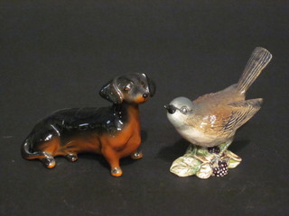 A Beswick figure of a White Throat 2106 2" and a seated figure  of a Dachshund 4"