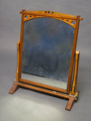 A Victorian aesthetic movement arched plate dressing table  mirror contained in an oak swing frame 26"