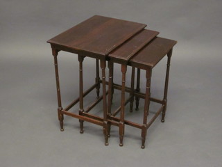 A nest of 3 Edwardian rectangular mahogany interfitting coffee tables, raised on turned and block supports 18"