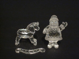 A Swarovski crystal figure of Father Christmas 2" and a figure of  a rocking horse 2"