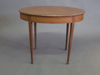 An Edwardian oval inlaid mahogany occasional table raised on  square tapering supports ending in spade feet 35"