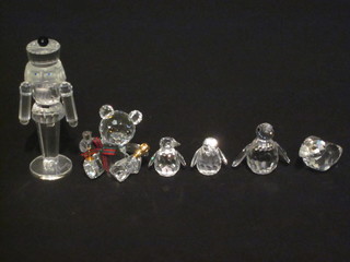 4 Swarovski crystal figures of a toy soldier, teddybear, figure of  3 penguins and a bird