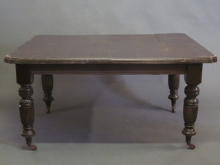 A Victorian oak extending dining table, raised on turned and reeded supports 57"