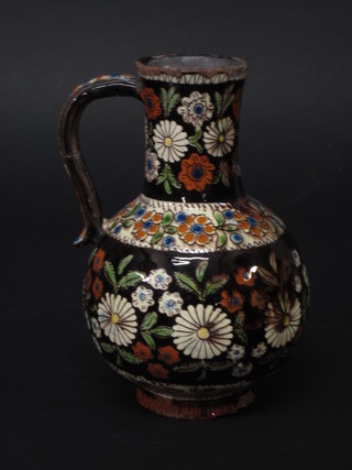 A Persian style pottery jug with floral decoration 7"