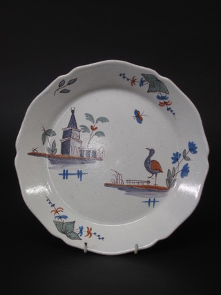 An 18th Century style Delft plate decorated building and bird 9"