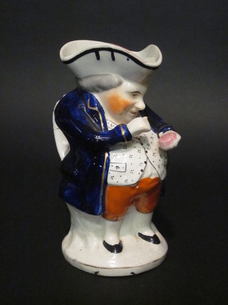 A 19th Century Staffordshire Toby jug in the form of Toby Philpots taking snuff, 9"