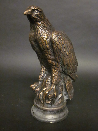 A plaster figure in the form of a seated eagle 15"