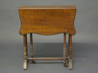 A Victorian shaped walnut Sutherland table, raised on turned supports 23"