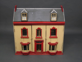 A dolls house in the form of a Victorian house