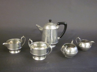 A Craftsman planished pewter 3 piece tea service comprising hotwater jug, twin handled sugar bowl and cream jug, together  with 2 Arundel pewter twin handled sugar bowls