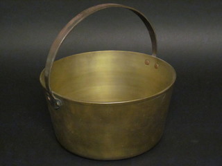 A brass preserving pan with polished steel handle