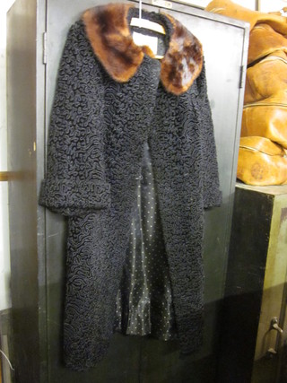 An Astrakhan fur coat with fur collar labelled Soldel Model