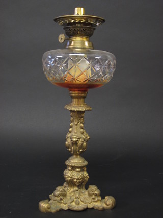 A cut glass oil lamp reservoir, raised on a cast brass stand