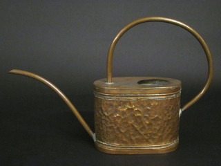An oval embossed copper watering can