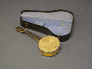 A 4 stringed banjo with 8 1/2" drum, the head marked Jondalls