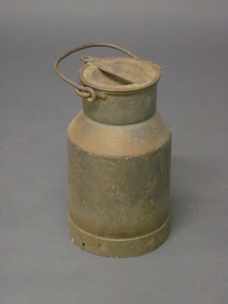 A cylindrical metal milk canister marked D E & Co 49
