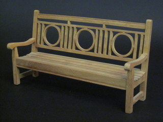 A wooden model of a slatted garden bench 14"
