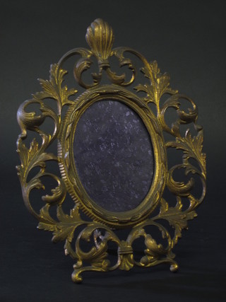 An oval pierced gilt metal easel photograph frame 11"  ILLUSTRATED