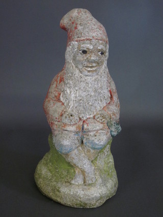 A stone figure of a seated gnome 16" high
