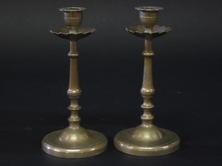 A pair of polished metal candlesticks 8"