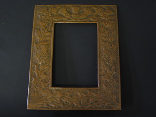 An Art Nouveau style embossed copper photograph frame with embossed thistles 9"