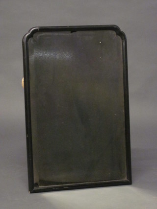 An arched bevelled plate mirror contained in an ebonised frame  14"