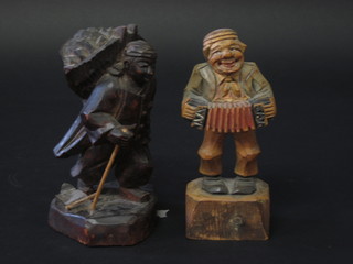 An Oriental carved wooden figure of a gentleman with panier 7" and a European figure of an accordionist 7"