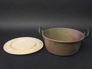 A brass twin handled preserve pan together with a circular  wooden bread board