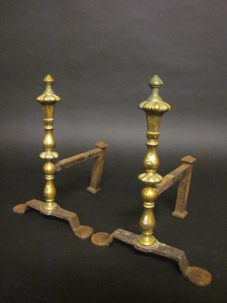 A pair of polished steel and brass fire dogs