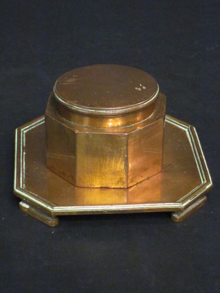 An octagonal copper inkwell raised on a stand 2 1/2"
