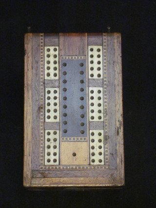 An inlaid mahogany folding cribbage board containing playing cards